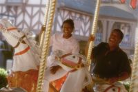 Guest ride Cinderella’s Golden Carousel in the Magic Kingdom theme park.